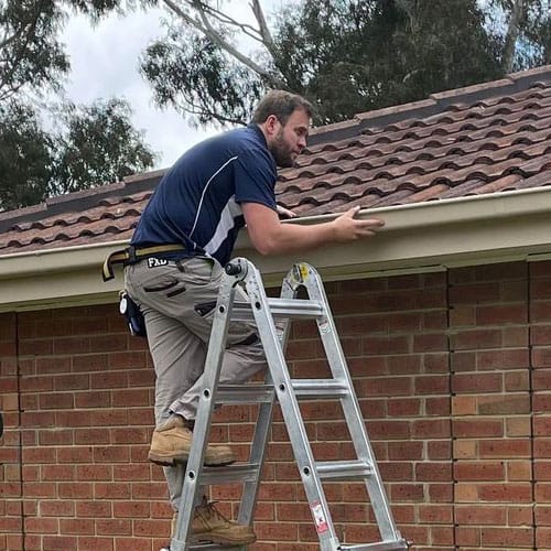 Tim from TSB Inspections, checking a gutter at a Pre-Purchase Building and Pest Inspections.